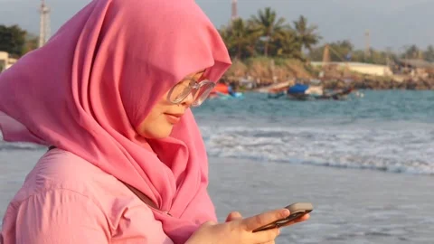 Woman using mobile phone at the beach Stock Footage 342087616