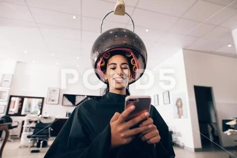 Woman using mobile phone at the beauty spa Stock Photos