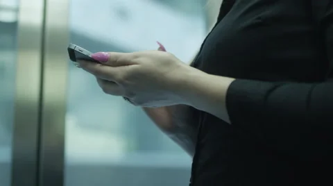 Woman is Using Mobile Phone in Elevator Stock Footage 39971099