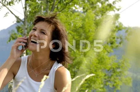 Woman Using Mobile Phone, Laughing