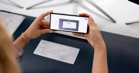 Woman Using Mobile Phone To Scan Paycheck For Salary Deposit. Foto stock