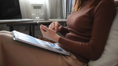 Woman using mobile phone, tablet.Closeup on blurred background Stock Footage 200870076