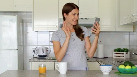 Woman using mobile phone talking via messenger app having video chat while Stock Footage 101343036