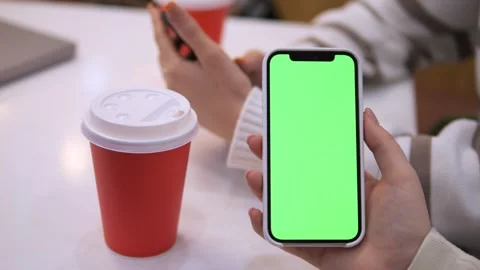 Woman using mobile phone vertical green screen. Female holding portable gadget Stock Footage 270315002