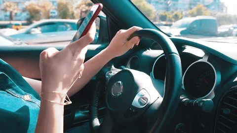 Woman using mobile phone when she is driving car.  Stock Footage 108960239