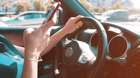Woman using mobile phone when she is driving car.  Stock Footage 108960295