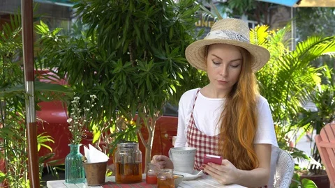 Woman using mobile phone while drinking tea. Stock Footage 88667602