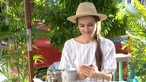 Woman using mobile phone while drinking tea. Stock Footage 88668999