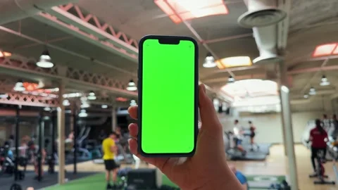 Woman using mobile phone while resting during fitness training. Hand holding Stock Footage 275024638