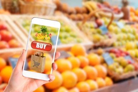 Woman using mobile phone while shopping in supermarket Stock Photos