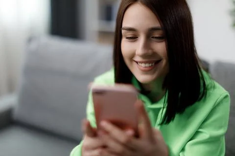 Woman using mobile on sofa Stock Photos