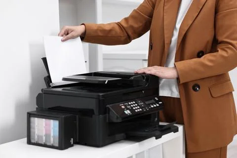 Woman using modern printer at workplace indoors, closeup Foto stock
