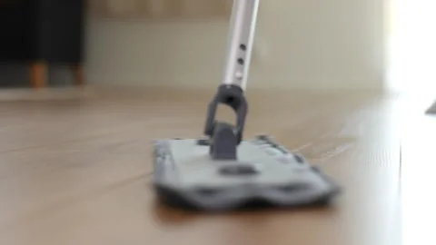 Woman using a mop to clean the floor, close-up Stockbeeldmateriaal 235662673