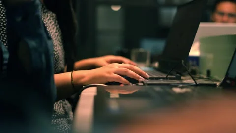 Woman using mouse while working on laptop Stock Footage 249731669