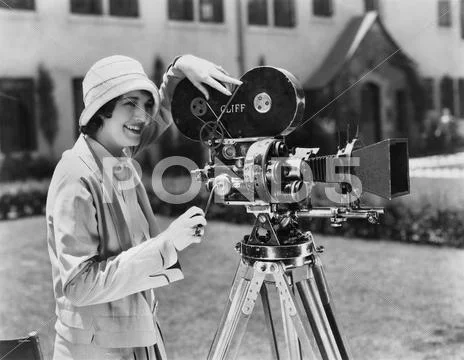 Woman using movie camera outdoors Stock Photos