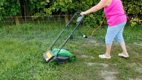 Woman using a mower Video stock 93846496