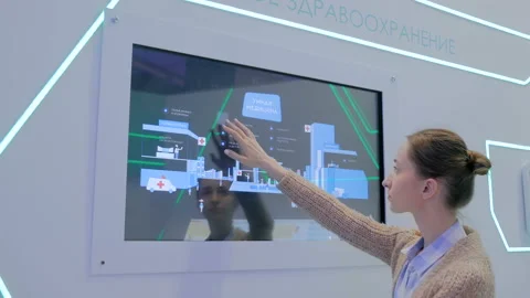 Woman using multimedia touchscreen display of interactive kiosk Stock Footage 121421923
