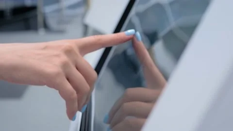 Woman using multimedia touchscreen display of interactive kiosk at exhibition Stock Footage 146872479