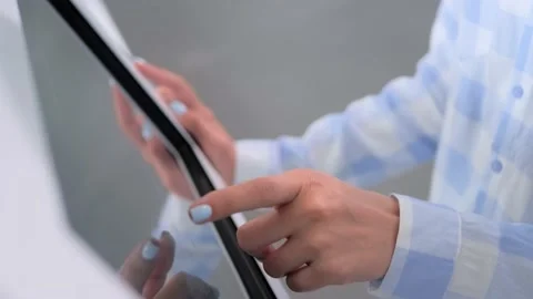 Woman using multimedia touchscreen display of interactive kiosk at exhibition Stock Footage 165623071