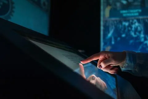 Woman using multimedia touchscreen display of interactive kiosk Stock Photos