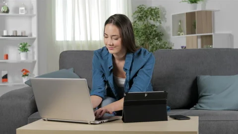 Woman using multiple devices and talking on phone Stock Footage
