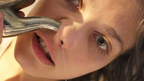 Woman using neti pot Stock Footage 105526633