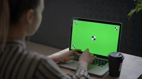 A woman using a notebook computer with a green screen Stock Footage 89516280