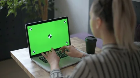 A woman using a notebook computer with a green screen Stock Footage 89516766