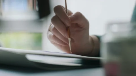 Woman using a paintbrush to paint Stock Footage 130245161