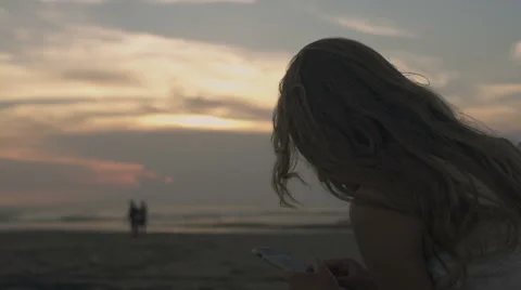Woman using phone at the beach Stock Footage 60072585