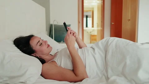 Woman Using Phone in Bed Stock Footage 310450973
