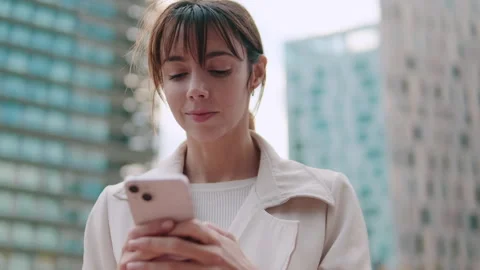 Woman Using Phone in City Setting Stock Footage 306486228