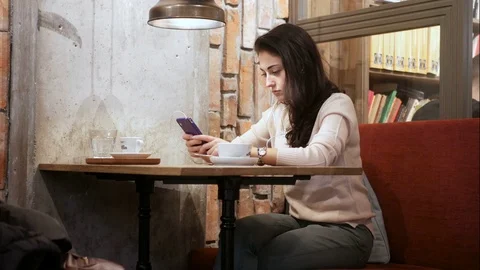 Woman using phone tablet computer in cafe Video stock 83324665