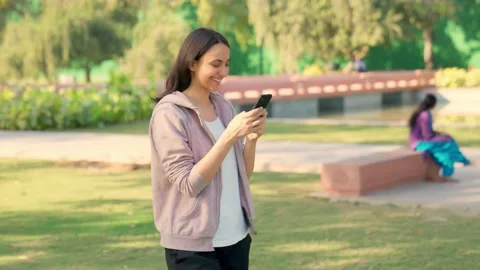 Woman using phone while walking 스톡 동영상 230581886