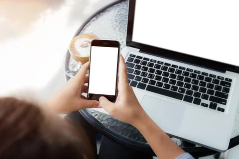 Woman using phone on work table in coffee shop Stock Photos