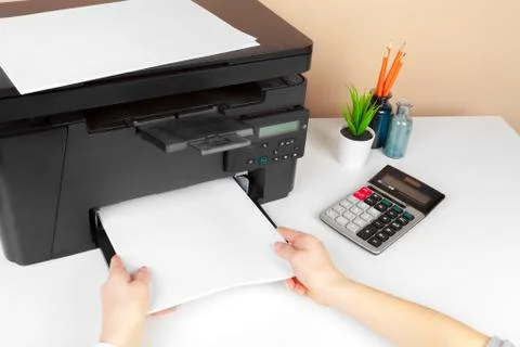 Woman using the printer to scanning and printing document Stock Photos