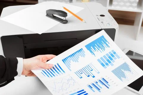 Woman using the printer to scanning and printing document Stock Photos