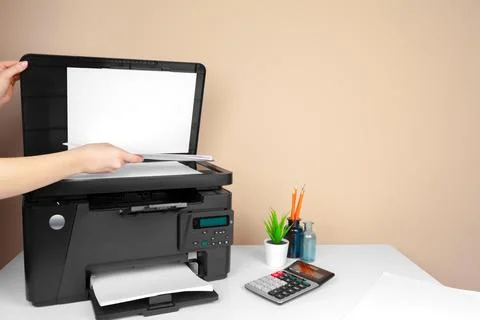 Woman using the printer to scanning and printing document Stock Photos