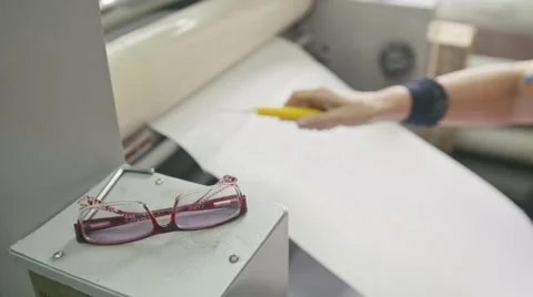 Woman using in printing machine, polygraph industry, front view, glasses in the Stock Footage