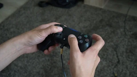 Woman using PS4 controller Stock Footage 94759707