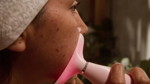 Woman Using Red Light Therapy Device for Acne Treatment Stock Footage 342737302