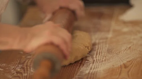 Woman using a rolling pin to flatten cookie dough, stock video Stock Footage 106326155