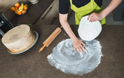 Woman using rolling pin preparing white fondant for cake decorating, hands de Stock Photos