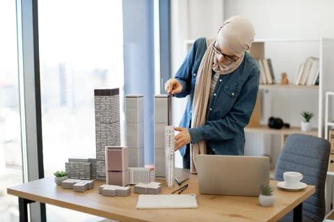 Woman using ruler while checking data on laptop at work Stock Photos
