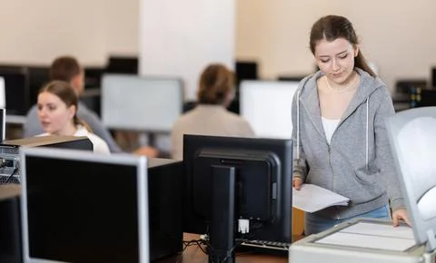 Woman using scanner in computer class in school Stock Photos