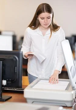 Woman using scanner in computer class in school Stock Photos