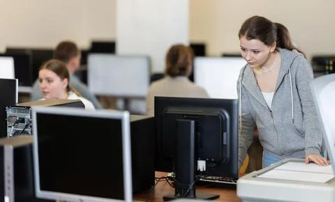 Woman using scanner in computer class in school Stock Photos