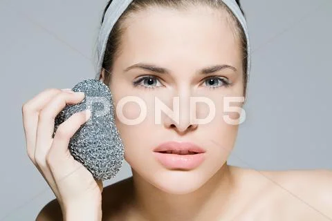 Woman Using Scouring Pad On Her Face