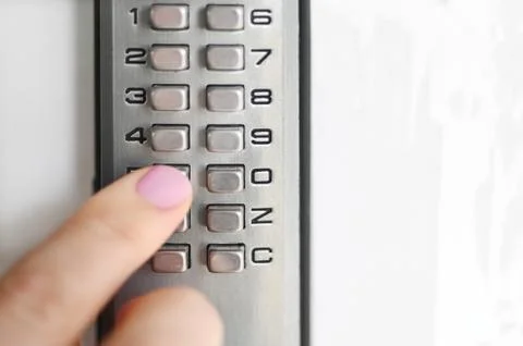 Woman using a secret code to open a door Stock Photos
