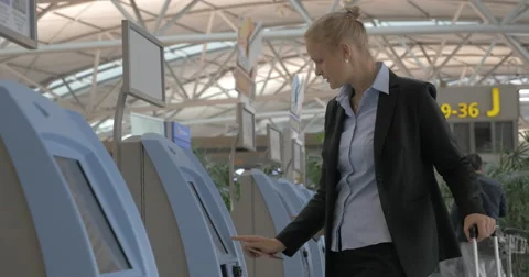 Woman using self check-in machine in the airport Stock Footage 67296786